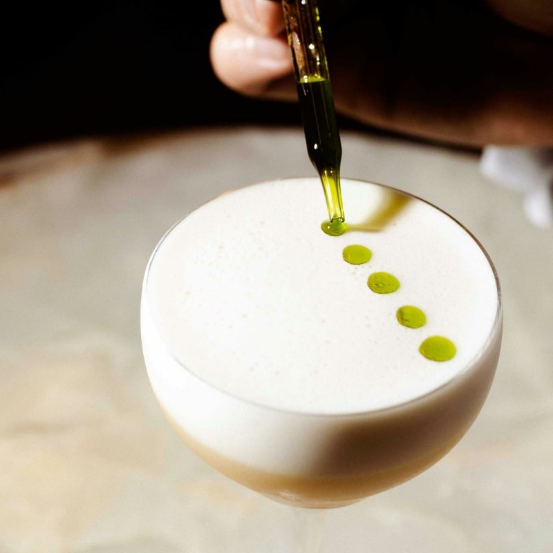Close up of mixologist preparing cocktail drink