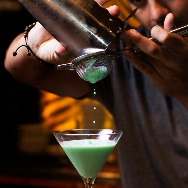 Close up of mixologist preparing cocktails and mocktails at mobile cocktail bar