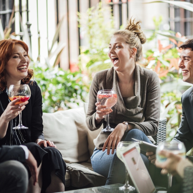 Business people drinking cocktails at a conference during a break