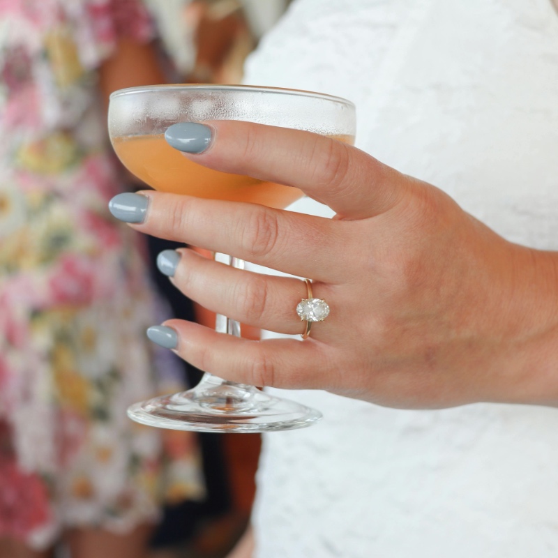 Close up of bride's hand at reception holding a wedding cocktail
