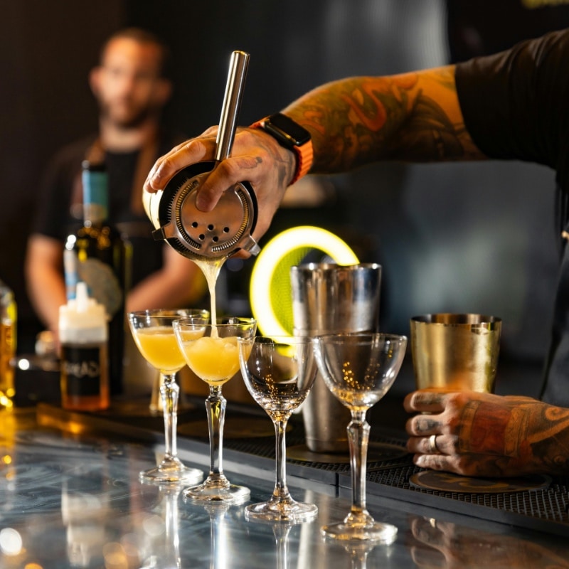 Close up of mixologist preparing cocktails at an event with a mobile cocktail bar